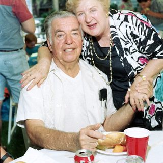 Joyful elderly couple posing together indoors.