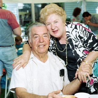 Joyful elderly couple posing together indoors.