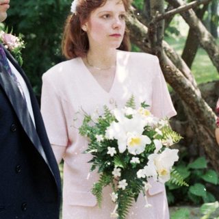 Wedding ceremony with bride, groom, officiant, and witnesses.
