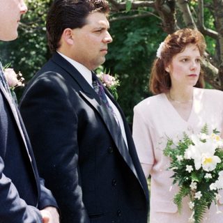Wedding ceremony with bride, groom, officiant, and witnesses.