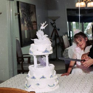 Family celebrating wedding with cake cutting.