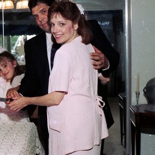 Family celebrating wedding with cake cutting.