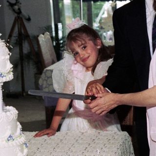 Family celebrating wedding with cake cutting.