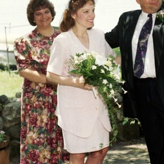 Wedding ceremony with bride, groom, and guests outdoors.