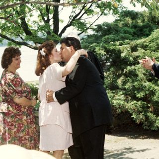 Wedding ceremony with couple sharing kiss.