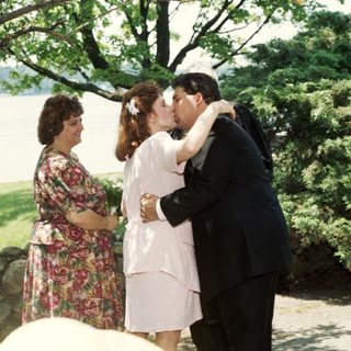 Wedding ceremony with couple sharing kiss.