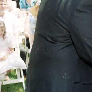 Wedding ceremony exchange of bouquets outdoors.