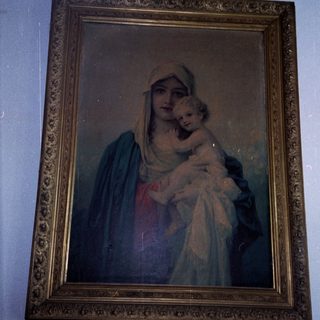 "Religious painting of Virgin Mary holding baby Jesus."