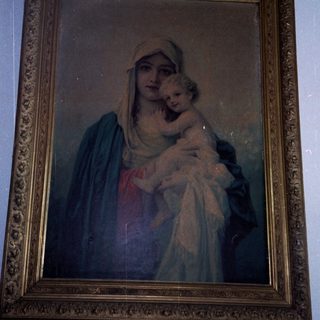 "Religious painting of Virgin Mary holding baby Jesus."