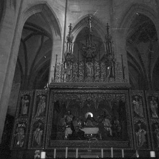 Gothic cathedral altar with intricate religious carvings.