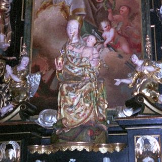 Baroque altar with ornate religious sculptures and paintings.