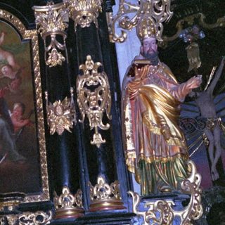 Baroque altar with ornate gold detailing and religious artwork.