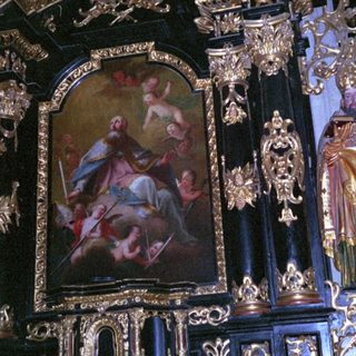Baroque altar with ornate gold detailing and religious artwork.