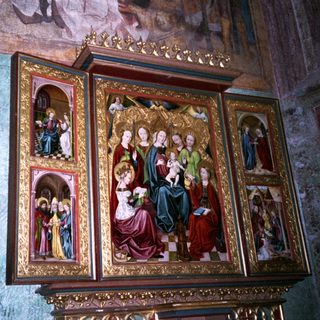 Elaborate religious iconostasis with golden religious scenes.