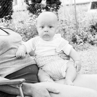 Baby sitting in outdoor chair.
