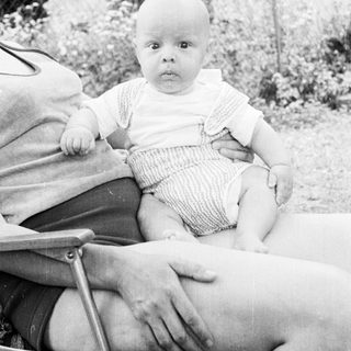Baby sitting in outdoor chair.