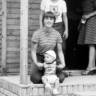 Family posing on porch with baby.