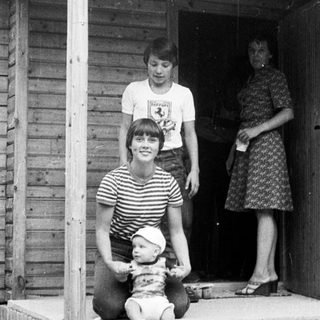 Family posing on porch with baby.