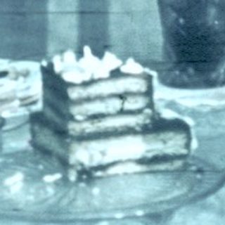 Reflection of vintage dining table with cake.