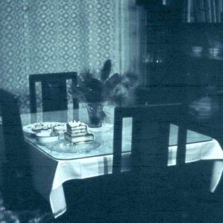 Reflection of vintage dining table with cake.
