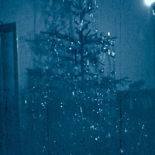 Christmas tree with hanging ornaments and lights.