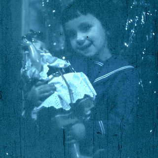 Blurred child holding stuffed animal near window.