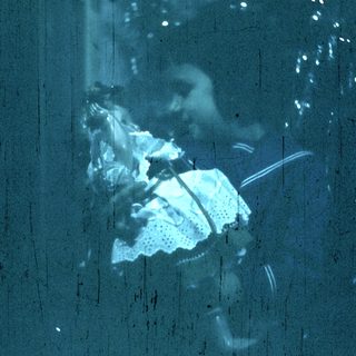 Blurred reflection of person holding folded towel.