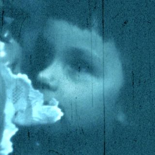 Blurred reflection of person holding camera.