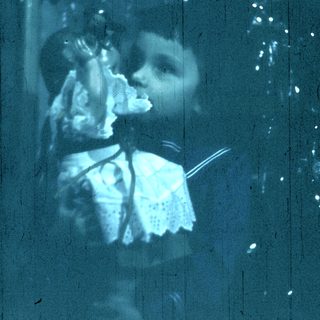 Blurred reflection of person holding camera.