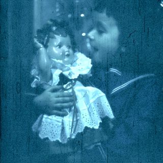 Blurred reflection of woman holding child indoors.
