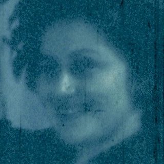 Reflection of woman in a train window.