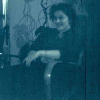 Reflection of woman in a train window.