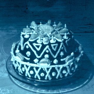 Elegant tiered cake with decorative frosting crown.
