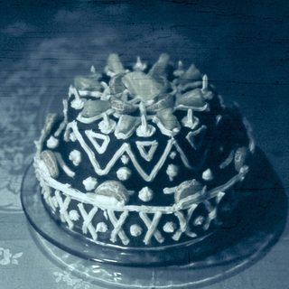 Elaborate traditional cake with intricate geometric decorations.