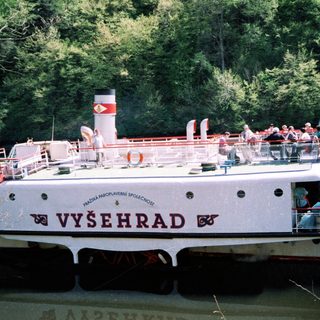 River cruise boat named Vyšehrad with passengers onboard.