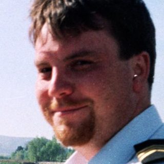 Man in naval uniform at a canal lock.