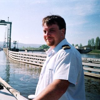 Man in naval uniform at a canal lock.
