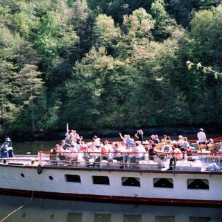 Boat tour with passengers on a river.