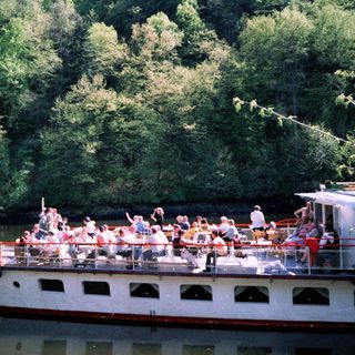 Boat tour with passengers on a river.