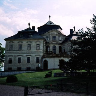 Elegant Baroque-style stone palace with gardens.