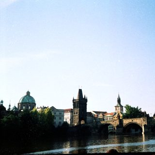 Historic Prague bridge with medieval architecture.