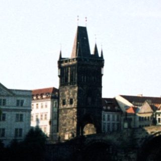 Historic Prague bridge with medieval architecture.