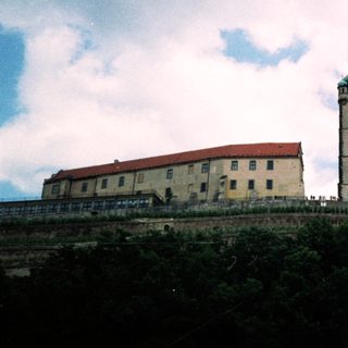 Historic castle complex with tall bell tower.