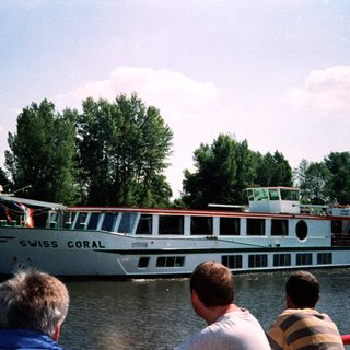 Swiss Coral river cruise boat passing.