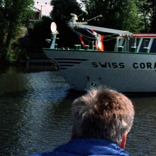Swiss Coral river cruise boat passing.
