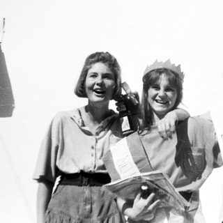 Three women posing happily, likely at a pageant or event.