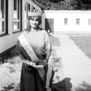 Homecoming queen in 1970s-style sash and crown.