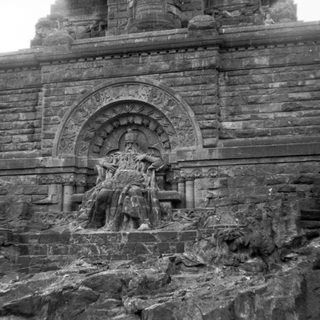 Relief sculpture on ancient stone temple wall.