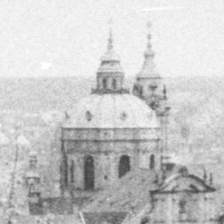 Historic cityscape with prominent church dome.