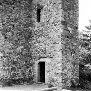 Old stone tower with small arched doorway.